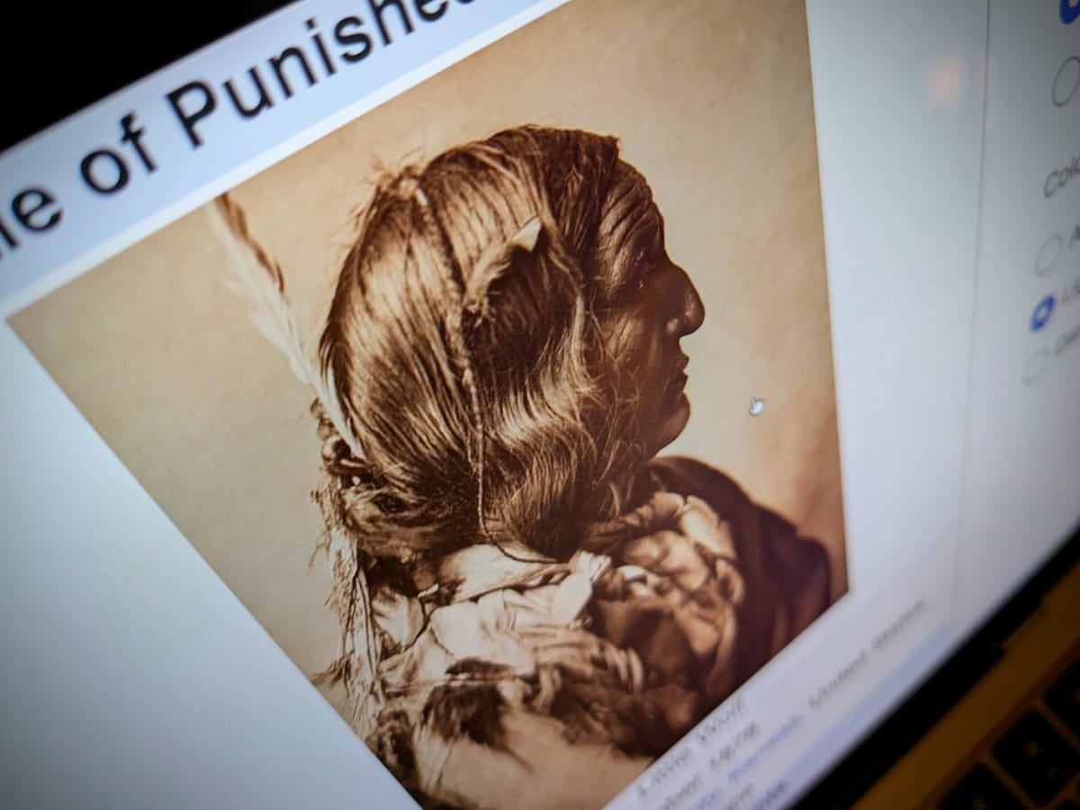 Photograph of a computer screen showing the Wikipedia article about the Battle of Punished Woman's Fork and a picture of Lone Wolf.